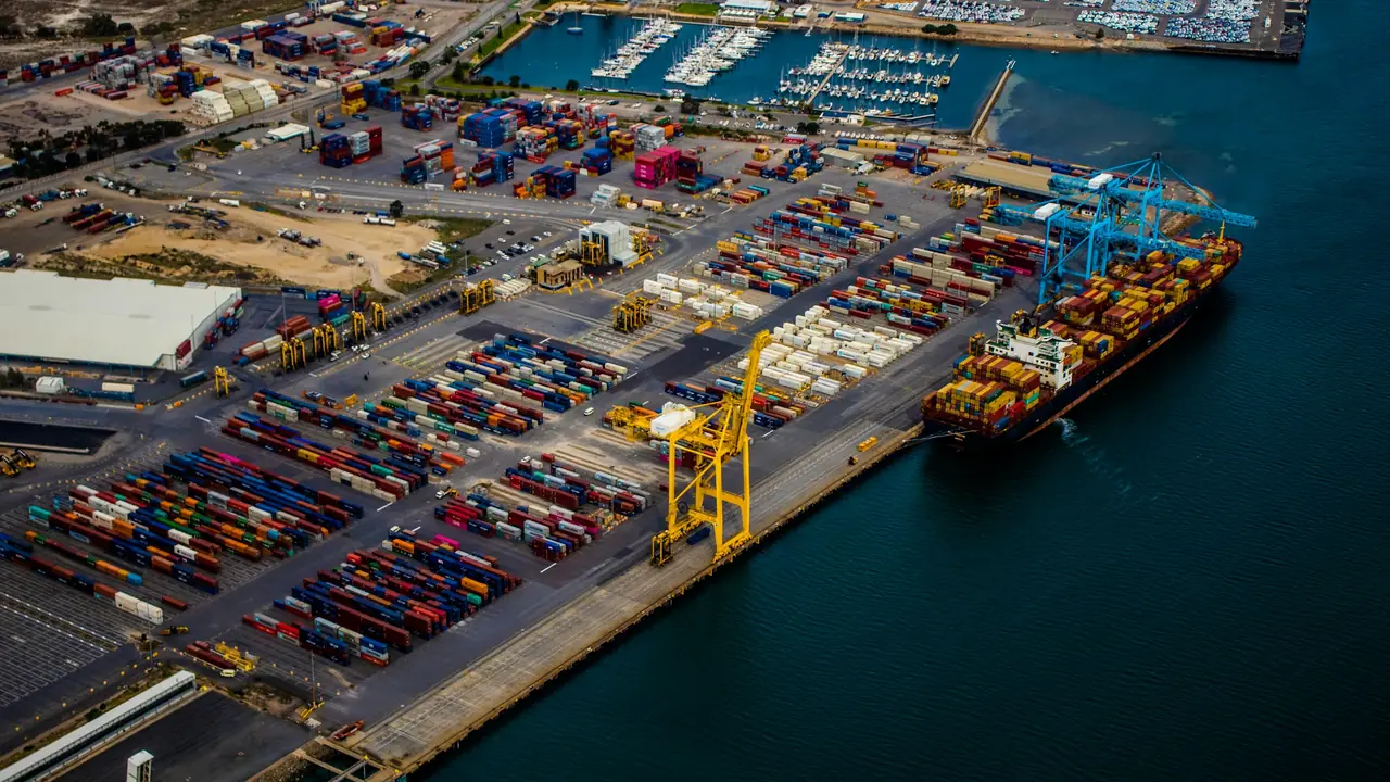 Aerial view of a container port with a cargo ship at the quay